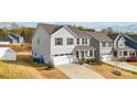 Well-maintained home featuring gray siding, a two-car garage, and manicured landscaping at 5104 Thomasville Dr, Belmont, NC 28012