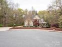 Charming two-story home with lush front lawn and inviting covered porch at 6108 Mcilwaine Rd, Huntersville, NC 28078
