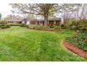 Expansive green lawn and manicured landscaping frame this brick home's exterior at 6307 Roanoke Dr # 17, Kannapolis, NC 28081