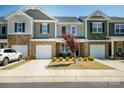 Inviting townhome with neat front lawn, one-car garage, and appealing architectural details at 7036 Heron Rookery Way, Charlotte, NC 28214
