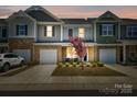 Charming townhome with a one-car garage, stone accents, and well-maintained landscaping at 7036 Heron Rookery Way, Charlotte, NC 28214