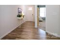 Open foyer featuring stylish wood-look flooring and a view into the home's living areas at 7036 Heron Rookery Way, Charlotte, NC 28214