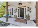 Inviting front porch features decorative plants, a stylish rug, and a cozy seating area at 835 Ryans Pl, Fort Mill, SC 29715