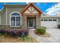 Close up of the charming front entrance with beautiful stone accents and covered porch at 8621 Sequoia Grove Ln, Charlotte, NC 28214