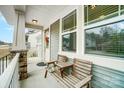 Inviting front porch with a cozy seating area, perfect for relaxing and enjoying the neighborhood views at 10161 Castlebrooke Dr, Concord, NC 28027