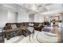 Spacious living room boasts hardwood floors, coffered ceilings, and a comfortable sectional sofa at 10161 Castlebrooke Dr, Concord, NC 28027