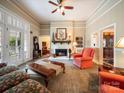 Cozy living room with fireplace, built-in bookshelves, and abundant natural light at 11 Tallassee St, Badin, NC 28009