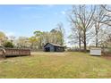 Large backyard featuring a detached garage/workshop and a wooden deck at 121 Tanglewood Dr, Kannapolis, NC 28081
