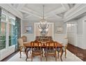Elegant dining room boasts stylish chandelier, neutral color palette, and backyard view at 138 Great Point Dr, Mooresville, NC 28117