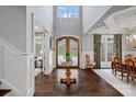 Bright and welcoming foyer with soaring ceiling, ornate front door, and rich hardwood flooring at 138 Great Point Dr, Mooresville, NC 28117