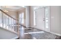 Bright entryway featuring hardwood floors, staircase, and natural light at 15964 Cumnor Ln, Charlotte, NC 28277