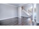 Spacious living room with hardwood floors, columns, and staircase at 15964 Cumnor Ln, Charlotte, NC 28277