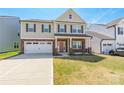 Charming two-story home with a two-car garage, manicured lawn, and covered front porch at 162 Aspire Cir, Wingate, NC 28174