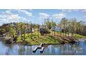 Beautiful waterfront homes featuring private dock, lush green lawns, and mature trees on a sunny day for lake living at 19650 Harbor Watch Ct, Lancaster, SC 29720