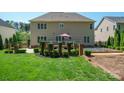Expansive backyard featuring a well-maintained lawn and a charming patio area, perfect for outdoor relaxation and entertaining at 202 Weeping Spring Dr, Mooresville, NC 28115