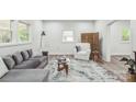 Cozy living room with a grey sofa, white armchair, and decorative rug at 221 N Davis Ave, Newton, NC 28658