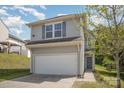 Two-story home with vinyl siding, a two-car garage, and a well-manicured lawn and landscaping at 244 Aershire Ct, Concord, NC 28025