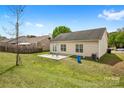 A spacious backyard with a concrete patio and well-maintained lawn offers outdoor living at 2659 Captains Watch Ne Rd, Kannapolis, NC 28083