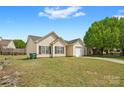 Charming single-story home featuring a well-maintained lawn and attached one car garage at 2659 Captains Watch Ne Rd, Kannapolis, NC 28083