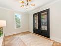 Elegant foyer features stylish herringbone floors, a modern light fixture, and a spacious layout at 2909 Hanson Dr, Charlotte, NC 28207