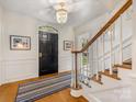 Bright foyer features hardwood floors, a staircase, and stylish decor at 2912 Wheelock Rd, Charlotte, NC 28211