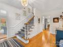 Welcoming foyer with hardwood floors, carpet runner and staircase at 2912 Wheelock Rd, Charlotte, NC 28211