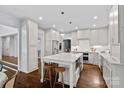 Open kitchen features a large island, stainless appliances, and white cabinetry providing ample storage at 2915 Cross Country Rd, Charlotte, NC 28270