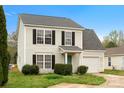 Charming two-story home with black shutters, a green front door, and an attached one-car garage at 3320 Alderknoll Ct, Charlotte, NC 28216