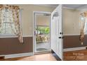 Inviting entryway with natural light streaming through the decorative front door and windows at 394 Efird St, Gastonia, NC 28054