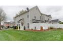 Well-manicured lawn and white fencing create a serene and private backyard retreat at 4130 Town Center Rd, Harrisburg, NC 28075
