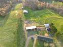 Overhead shot capturing various buildings, lush greenery, and a well-maintained yard on the property at 5373 Nc Hwy 16 N Hwy, Taylorsville, NC 28681