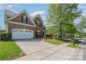 Beautiful brick home featuring a spacious driveway, two-car garage, and a lovely front yard at 9013 Gailes Dr, Charlotte, NC 28278