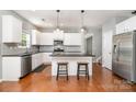 Bright kitchen with white cabinets, stainless steel appliances, and granite countertops at 9013 Gailes Dr, Charlotte, NC 28278