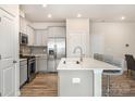 Bright, modern kitchen with stainless steel appliances and a large island with breakfast bar at 9654 Old Garden Cir, Gastonia, NC 28056
