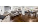 Open concept living room featuring hardwood floors and view into kitchen at 9718 Barkridge Rd, Mint Hill, NC 28227
