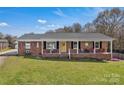 Charming brick ranch home with a cozy front porch and inviting yellow front door at 109 Connor Ct, Kings Mountain, NC 28086