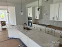 Bright kitchen featuring white cabinets, modern appliances, and a central island at 1110 Sugar Creek Rd, Indian Land, SC 29707