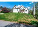 Beautiful two-story brick home on a landscaped hill featuring a manicured front yard and inviting entrance at 112 Whitman Ct # 275, Taylorsville, NC 28681