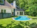Backyard swimming pool, perfect for relaxation and entertainment surrounded by lush greenery at 117 Wrenwood Ln, Charlotte, NC 28211