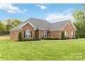 Side view of the house with a manicured lawn at 15118 Marshall Valley Ct, Mint Hill, NC 28227