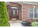 Close up of the front door with decorative glass and sidelights at 15118 Marshall Valley Ct, Mint Hill, NC 28227