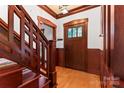 Inviting entryway with hardwood floors, detailed wood trim, and a staircase at 1536 Bear Mountain Rd, Charlotte, NC 28214