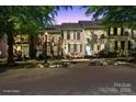 Charming brick townhomes featuring well-maintained landscaping and classic architectural details at twilight at 164 Singleton Rd, Mooresville, NC 28117