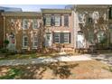Beautiful brick townhome with black shutters, well maintained landscaping, and inviting entrance at 164 Singleton Rd, Mooresville, NC 28117