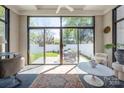 Sunroom with slate tile floor and large sliding glass doors to the backyard at 1842 Asheville Pl, Charlotte, NC 28203