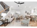 Bright and inviting living room featuring stylish décor, a modern staircase, and an open floor plan at 2003 Ashley Rd # B, Charlotte, NC 28208