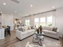 Bright and spacious living room with neutral tones, two sofas and many windows offering a view at 2104 Morgan Hill Dr, Albemarle, NC 28001