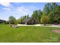 Expansive lawn surrounds this elegant brick home, set back from the road and framed by mature trees at 2840 Wheatfield Ct, Lincolnton, NC 28092