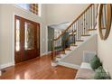 Inviting foyer with hardwood floors, staircase with wrought iron railings, and ample natural light at 2840 Wheatfield Ct, Lincolnton, NC 28092