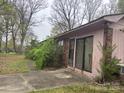 Side view of a single story brick home with a covered front entrance with a concrete patio at 307 Brook St, Salisbury, NC 28146